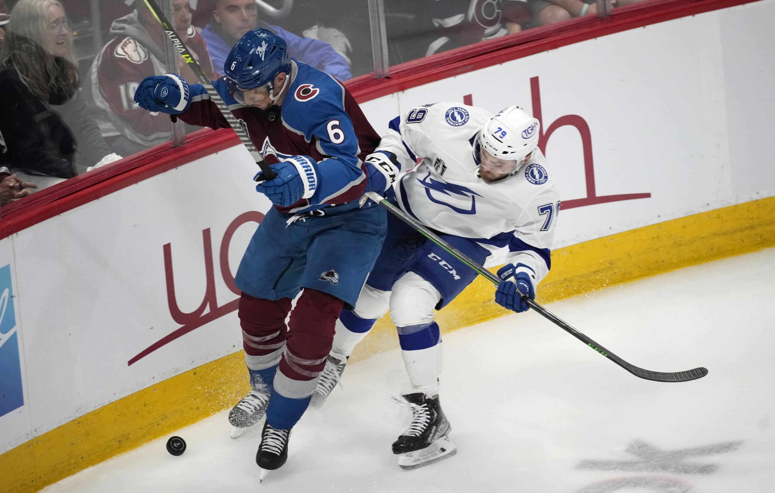 Colorado Avalanche defenseman Erik Johnson, left, and Tampa Bay Lightning center Ross Colton vie for the puck during the third period of Game 5 of the NHL hockey Stanley Cup Final, Friday, June 24, 2022, in Denver. (AP Photo/David Zalubowski)