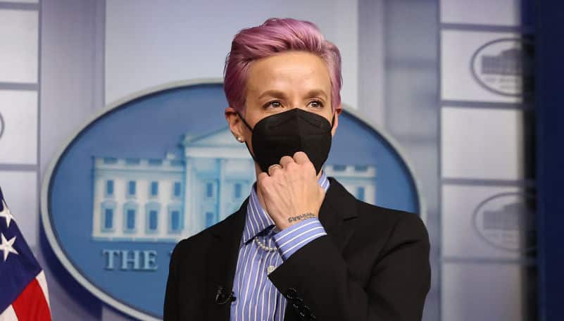 Professional soccer player Megan Rapinoe stands at the podium of the Brady Press Briefing Room before meeting with President Joe Biden on March 24, 2021 in Washington, DC.