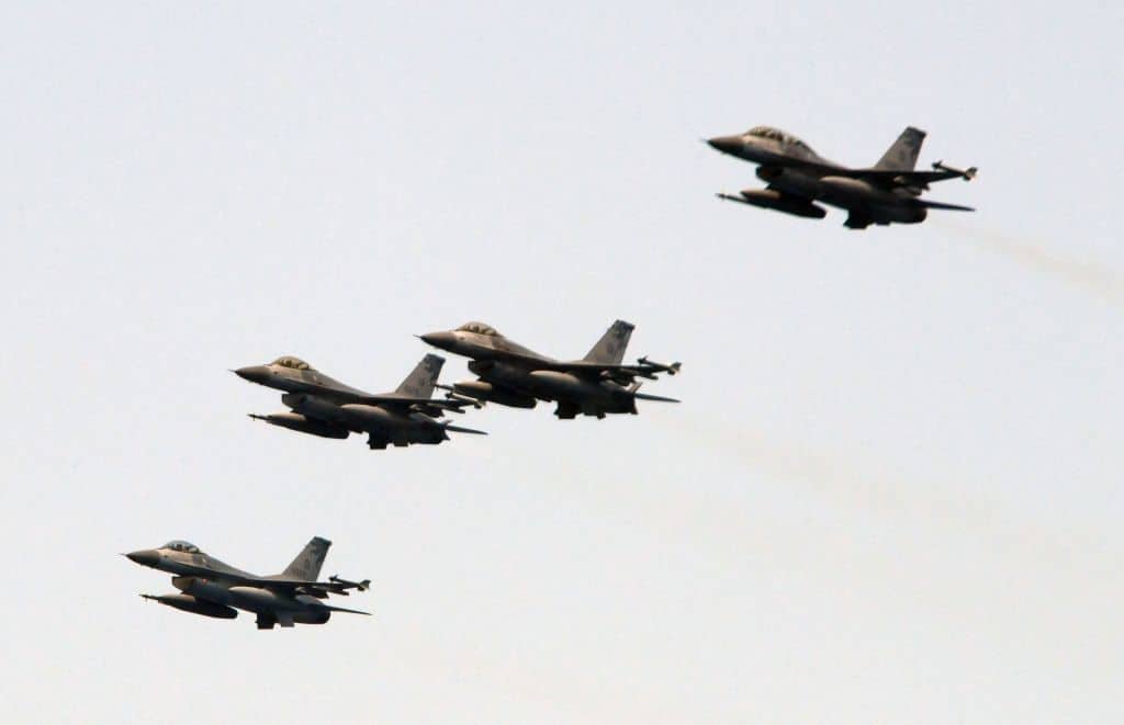 Four US-made F-16 fighter jets cross the sky during a drill near the Suao navy harbour in Yilan, eastern Taiwan, on April 13, 2018.
Taiwan's president watched naval drills simulating an attack on the island on April 13, days before Beijing is set to hold live-fire exercises nearby in a show of force. / AFP PHOTO / SAM YEH        (Photo credit should read SAM YEH/AFP via Getty Images)