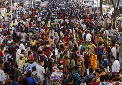 People crowd a market place for Diwali festival shopping in Mumbai, India, Thursday, Nov. 12, 2020. Authorities in New Delhi have banned firecrackers and are appealing to people to celebrate the Hindu festival of lights at home. Coronavirus infections have been rising in the capital and authorities are worried large festival crowds will worsen the virus situation.(AP Photo/Rajanish Kakade)