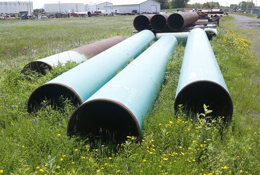 FILE - In this June 29, 2018, file photo, pipeline used to carry crude oil is shown at the Superior, Wis., terminal of Enbridge Energy.  The sponsor of the Keystone XL crude oil pipeline says it's pulling the plug on the contentious project, Wednesday, June 9, 2021,  after Canadian officials failed to persuade the Biden administration to reverse its cancellation of the company's permit.  (AP Photo/Jim Mone, File)