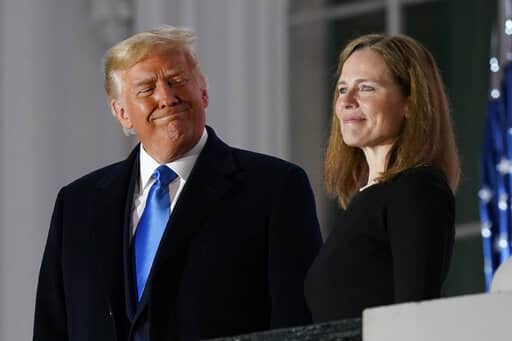 FILE - President Donald Trump and Amy Coney Barrett stand on the Blue Room Balcony after Supreme Court Justice Clarence Thomas administered the Constitutional Oath to her on the South Lawn of the White House White House in Washington, Oct. 26, 2020. The Supreme Court's decision that women have no constitutional right to an abortion marked the apex of a week that reinforced Trump's grip on Washington more than a year and a half after he exited the White House for the final time. The same Supreme Court now dominated by Trump-appointed conservatives also voted to weaken restrictions on gun ownership. (AP Photo/Patrick Semansky, File)