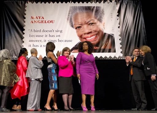First lady Michelle Obama participates in the unveiling of the Maya Angelou Forever Stamp, Tuesday, April 7, 2015, at the Warner Theater in Washington. From left are, poet Sonia Sanchez; Eleanor Traylor, English Professor at Howard University; poet Nikki Giovanni; Mrs. Obama; Postmaster General Megan Brennan; Oprah Winfrey, artist Ross Rossin, and Ethel Kessler, art director for stamps with the U.S. Postal Service. (AP Photo/Jacquelyn Martin)