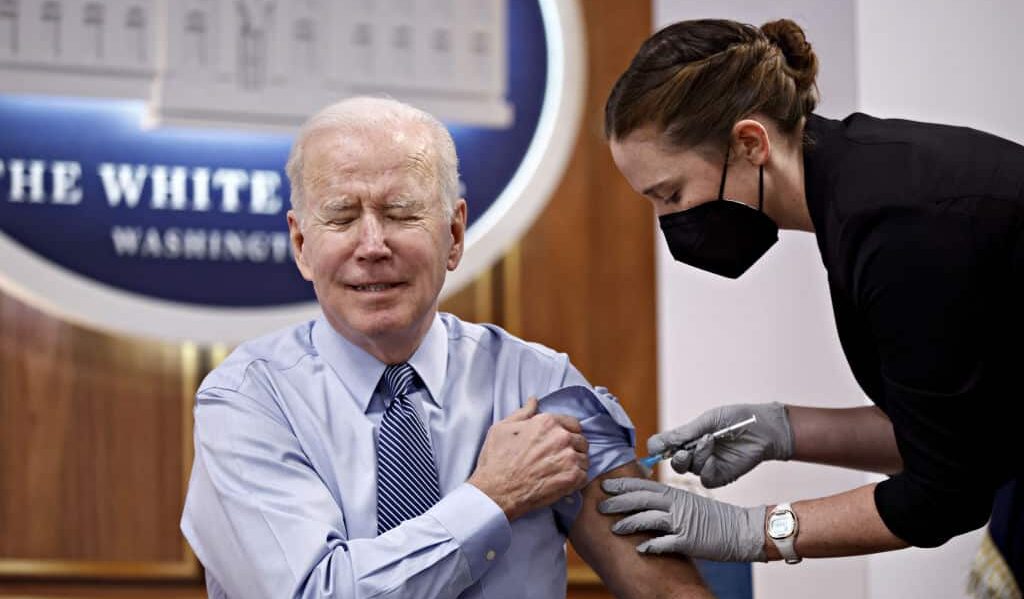 U.S. President Joe Biden receives a booster dose of the Pfizer-BioNTech Covid-19 vaccine administered by a member of the White House Medical Unit in the Eisenhower Executive Office Building in Washington, D.C., U.S., on Wednesday, March 30, 2022. Biden unveiled a new website where Americans can find recommendations for mitigating Covid-19 risks that are specific to their area. Photographer: Ting Shen/Bloomberg via Getty Images