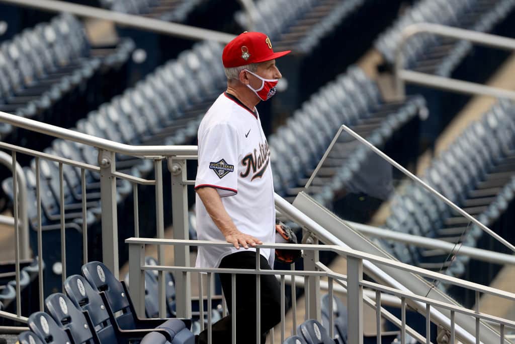 WASHINGTON, DC - JULY 23: Dr. Anthony Fauci, director of the National Institute of Allergy and Infectious Diseases walks to the field to throw out the ceremonial first pitch prior to the game between the New York Yankees and the Washington Nationals at Nationals Park on July 23, 2020 in Washington, DC. (Photo by Rob Carr/Getty Images)