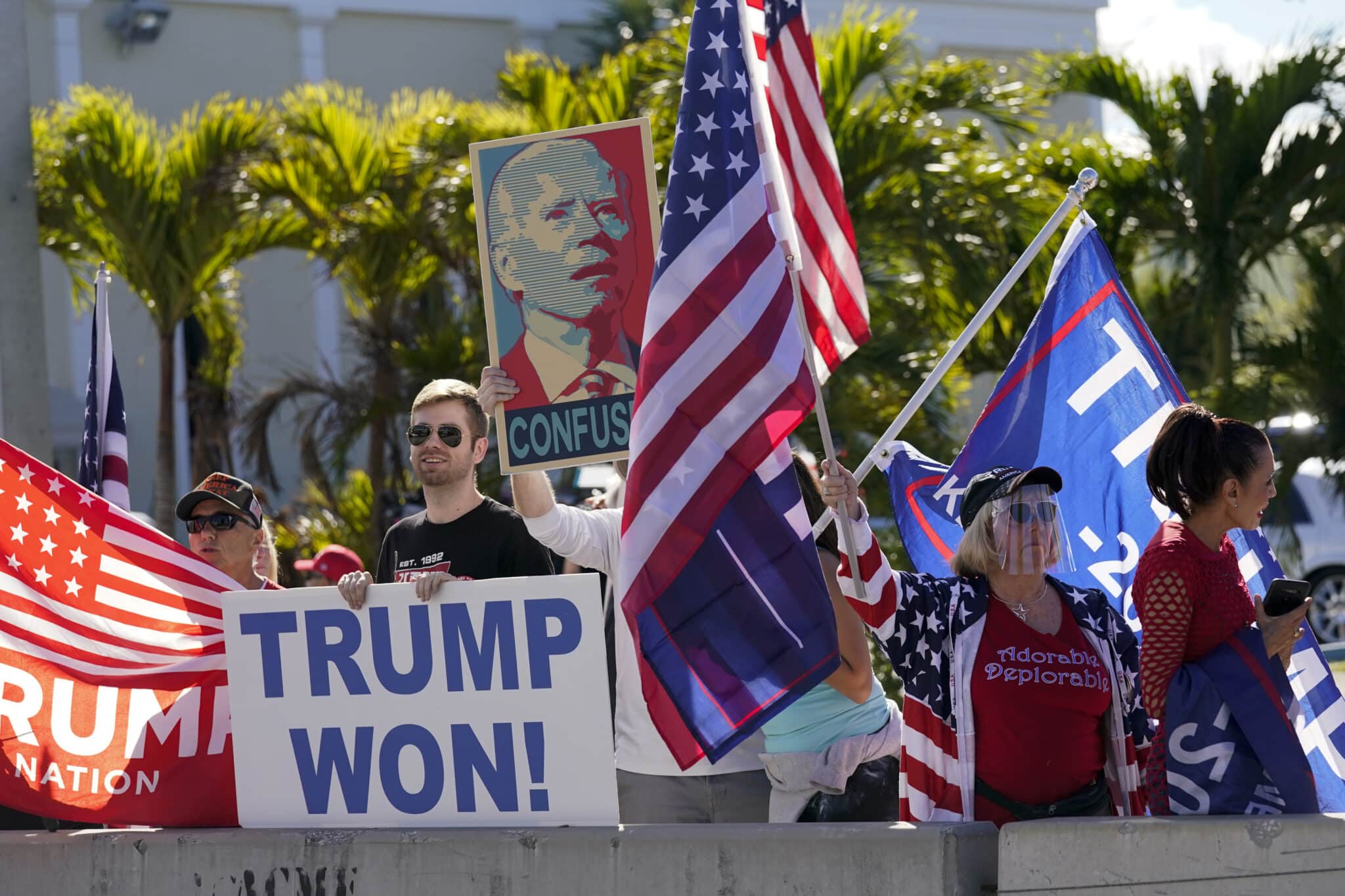 Supporters of President Donald Trump wait for the motorcade on the road to Mar-a-Lago, Trump's Palm Beach estate, on Wednesday, Jan. 20, 2021, in West Palm Beach, Fla. (AP Photo/Lynne Sladky)