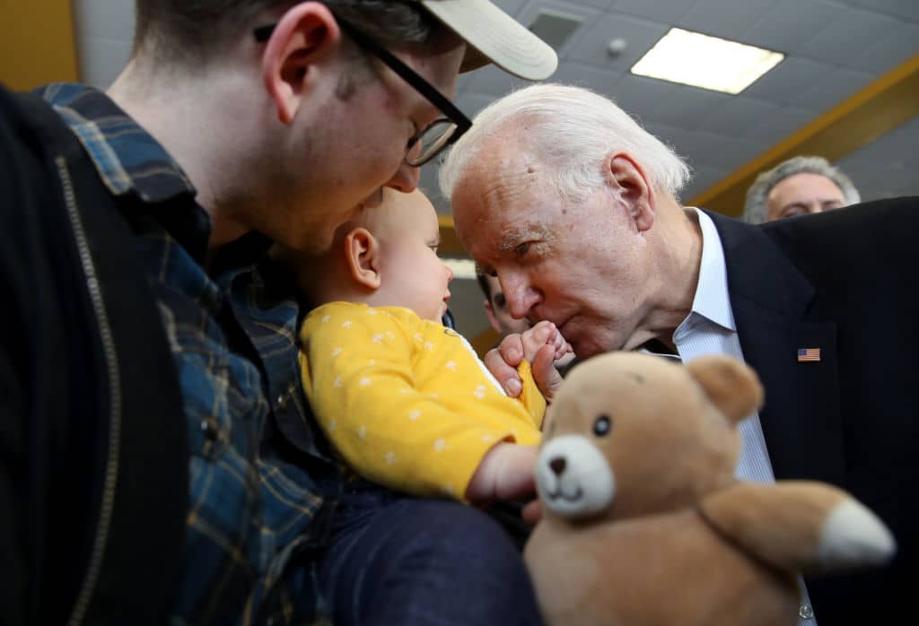 DUBUQUE, IOWA - FEBRUARY 02: Democratic presidential candidate former Vice President Joe Biden (R) greets a baby during a campaign event on February 02, 2020 in Dubuque, Iowa. With one day to  go before the 2020 Iowa Presidential caucuses, Joe Biden is campaigning across Iowa.  (Photo by Justin Sullivan/Getty Images)