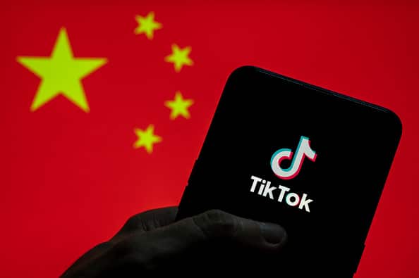 CHINA - 2021/03/28: In this photo illustration the Chinese video-sharing social networking service company TikTok logo seen on an Android mobile device with People's Republic of China flag in the background. (Photo Illustration by Budrul Chukrut/SOPA Images/LightRocket via Getty Images)