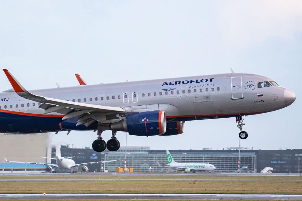 An Aeroflot - Russian Airlines Airbus A320 aircraft as seen on final approach flying and landing on the runway at Amsterdam Schiphol Airport with the terminal and the control tower visible, after arriving from Moscow. The A320-200 jet airplane has the registration VP-BTJ and the name A. Rublev / ?. ??????. Aeroflot AFL is the flag carrier and largest airline of the Russian Federation with a fleet of 202 planes, member of SkyTeam aviation alliance group. The Government of Russia owns 51% of the airline. The aviation industry and passenger traffic is phasing a difficult period with the Covid-19 coronavirus pandemic having a negative impact on the travel business industry with fears of the deteriorating situation due to the new Omicron variant mutation. Amsterdam, the Netherlands on January 5, 2022 (Photo by Nicolas Economou/NurPhoto via Getty Images)