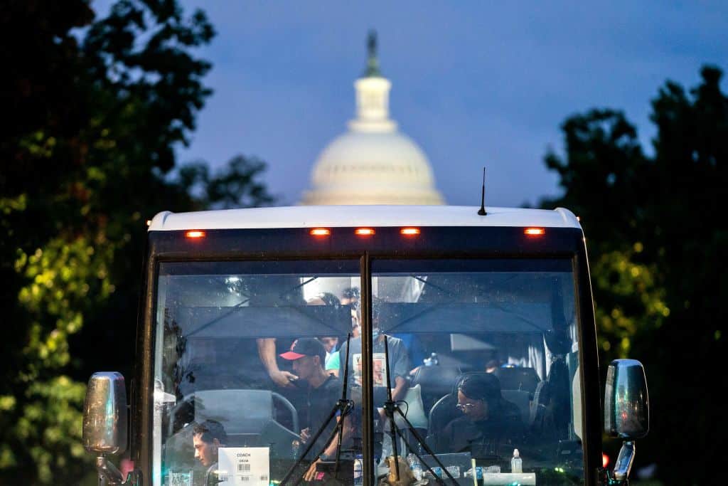 Migrants, who boarded a bus in Texas, are dropped off within view of the US Capitol in Washington, DC, on August 11, 2022. - Since April, Texas Governor Greg Abbott has ordered buses to carry thousands of migrants from Texas to Washington, DC, and New York City to highlight criticisms of US President Joe Bidens border policy. (Photo by Stefani Reynolds / AFP) (Photo by STEFANI REYNOLDS/AFP via Getty Images)