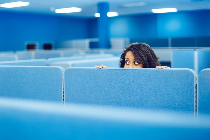 Office worker eavesdropping in cubicle room