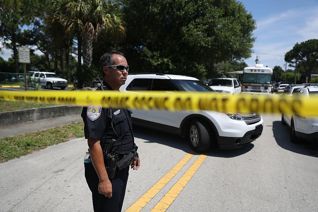 FORT PIERCE, FL - JUNE 12:  Police tape marks off the entrance to the apartment building where shooting suspect Omar Mateen is believed to have lived on June 12, 2016 in Fort Pierce, Florida. The mass shooting at Pulse nightclub in Orlando, Florida killed at least 50 people and injured 53 others in what is the deadliest mass shooting in the country's history.  (Photo by Joe Raedle/Getty Images)