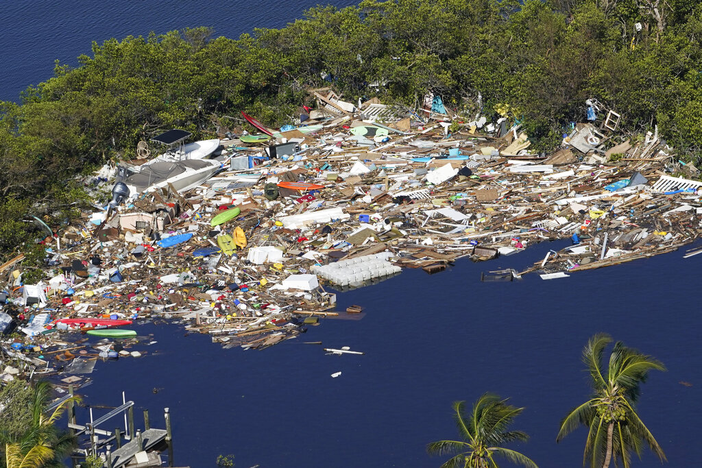 Debris is piled up at the end of a cove following heavy winds and storm surge caused by Hurricane Ian Thursday, Sept. 29, 2022, in Barefoot Beach, Fla. (AP Photo/Marta Lavandier)