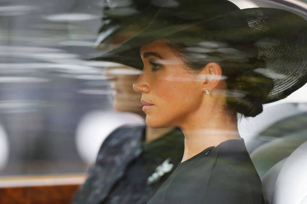 Meghan, Duchess of Sussex follows the coffin of Queen Elizabeth II, draped in the Royal Standard, and placed on the State Gun Carriage of the Royal Navy, as it travels from Westminster Abbey to Wellington Arch in London on September 19, 2022, after the State Funeral Service of Britain's Queen Elizabeth II. (Photo by Tom Jenkins / POOL / AFP) (Photo by TOM JENKINS/POOL/AFP via Getty Images)