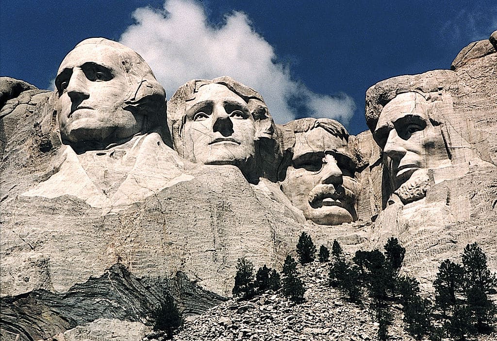 KEYSTONE, UNITED STATES:  This June 1995 photo shows Mt. Rushmore, in Keystone, South Dakota. Sculptor Gutzon Borglum started work on Mt. Rushmore 10 Aug 1927 and continued for 14 years, but only 6.5 years were actually spent sculpting due to harsh weather delays. The presidents were selected on the basis of what each symbolized. George Washington (L) represents the struggle for independence; Thomas Jefferson (2nd L), the idea of government by the people; Theodore Roosevelt (2nd R), for the 20th century role of the United States in world affairs; and Abraham Lincoln (R) for his ideas on equality and the permanent union of the states. AFP PHOTO/KAREN BLEIER  (Photo credit should read KAREN BLEIER/AFP via Getty Images)