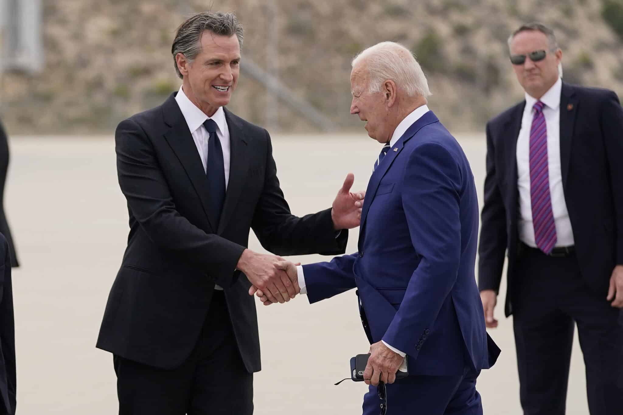 President Joe Biden, right, greets California Gov. Gavin Newsom after arriving at Los Angeles International Airport to attend the Summit of the Americas, Wednesday, June 8, 2022, in Los Angeles. (AP Photo/Evan Vucci)
