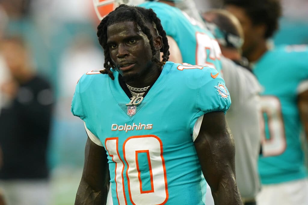 Miami Dolphins wide receiver Tyreek Hill (10) takes a break as he warms up before the start of an NFL preseason football game against the Las Vegas Raiders, Saturday, Aug. 20, 2022, in Miami Gardens, Fla. (AP Photo/Wilfredo Lee)