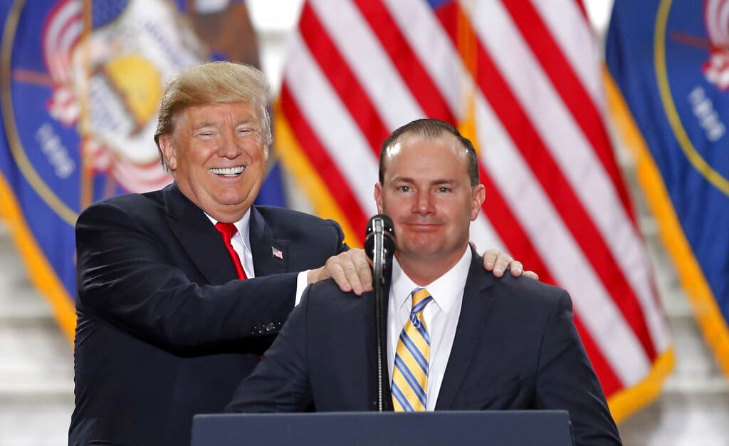 FILE - President Donald Trump stands with Sen. Mike Lee, R-Utah, on Dec. 4, 2017, at the Utah State Capitol. Lee, after sailing to victory in past elections, is being pushed by independent Evan McMullin toward uncharted waters, into a race that will test how Trump loyalists fare with voters when offered choices beyond the two-party system. (AP Photo/Rick Bowmer, File)