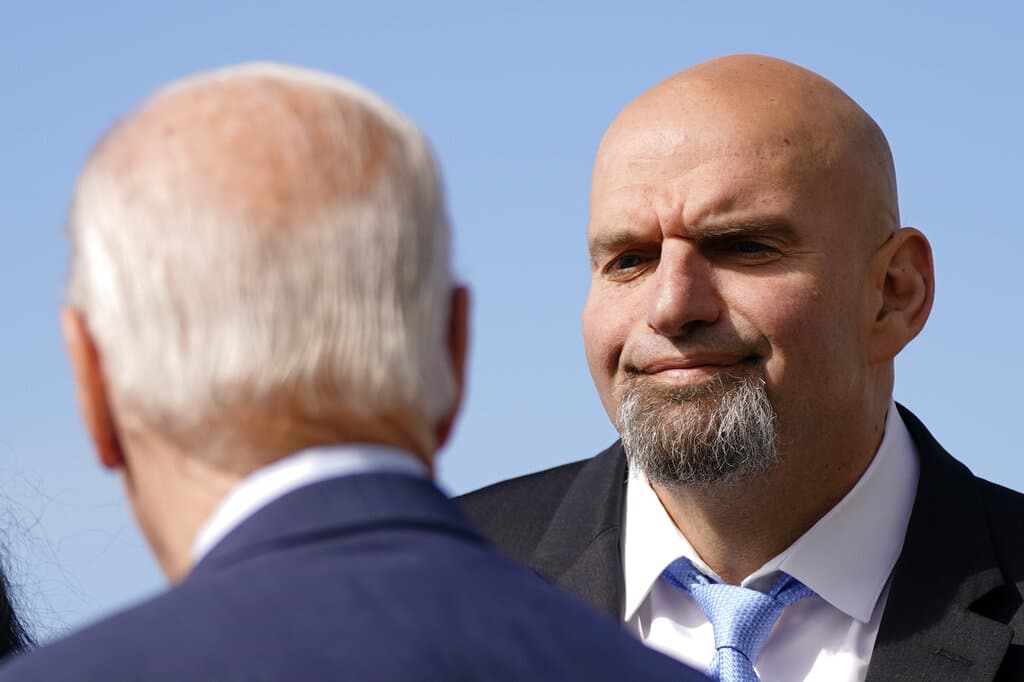 Pennsylvania Lt. Gov. John Fetterman, a Democratic candidate for U.S. Senate, stands on the tarmac after greeting President Joe Biden, front left, Thursday, Oct. 20, 2022, at the 171st Air Refueling Wing at Pittsburgh International Airport in Coraopolis, Pa. Biden is visiting Pittsburgh to promote his infrastructure agenda. (AP Photo/Patrick Semansky)