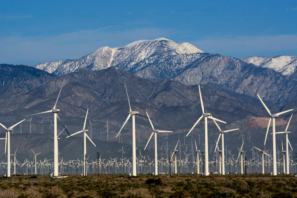 PALM SPRINGS, CALIFORNIA - FEBRUARY 27, 2019: Wind turbines generate electricity at the San Gorgonio Pass Wind Farm near Palm Springs, California, with snow-covered Mt. San Jacinto in the background. Located in the windy gap between Southern California's two highest mountains, the facility is one of three major wind farms in California. (Photo by Robert Alexander/Getty Images)