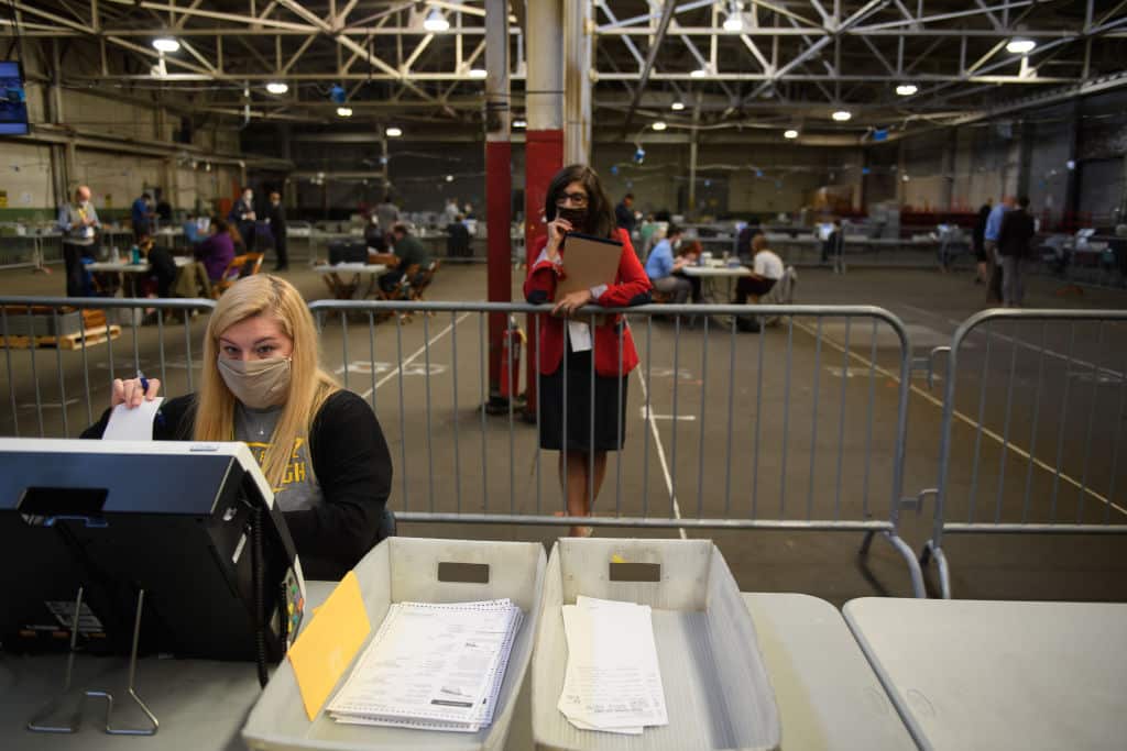 PITTSBURGH, PA - NOVEMBER 06: A  poll watcher monitors the counting of ballots at the Allegheny County elections warehouse on November 6, 2020 in Pittsburgh, Pennsylvania. Counting continues as Biden edged ahead of President Donald Trump in Pennsylvania for the first time Friday and leads the president by more than 6,000 votes, a difference of 0.1%. (Photo by Jeff Swensen/Getty Images)
