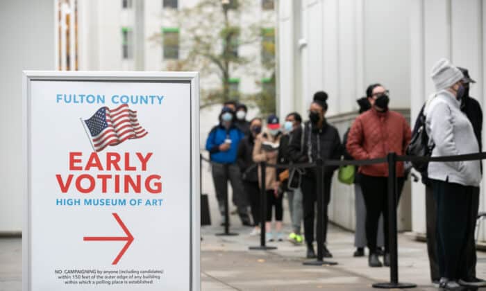 ATLANTA, GA - DECEMBER 14: Voters line up for the first day of early voting outside of the High Museum polling station on December 14, 2020 in Atlanta, Georgia. Georgians are headed to the polls to vote in a run off election for two U.S. Senate seats.  (Photo by Jessica McGowan/Getty Images)