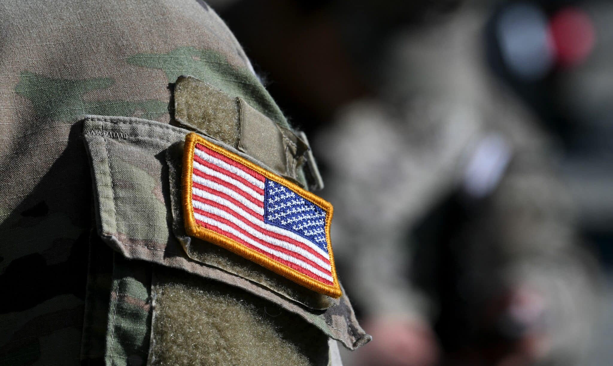 A US flag is pictured on a soldier's uniform at the United States Army military training base in Grafenwoehr, southern Germany, on March 11, 2022. (Photo by Christof STACHE / AFP) (Photo by CHRISTOF STACHE/AFP via Getty Images)