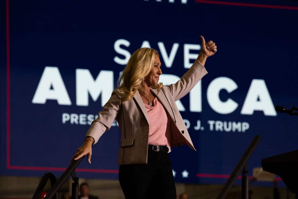 WARREN, MI - OCTOBER 01: Rep. Majorie Taylor Greene (R-GA) waves to the crowd during a Save America rally on October 1, 2022 in Warren, Michigan. Trump has endorsed Republican gubernatorial candidate Tudor Dixon, Secretary of State candidate Kristina Karamo, Attorney General candidate Matthew DePerno, and Republican businessman John James ahead of the November midterm election. (Photo by Emily Elconin/Getty Images)