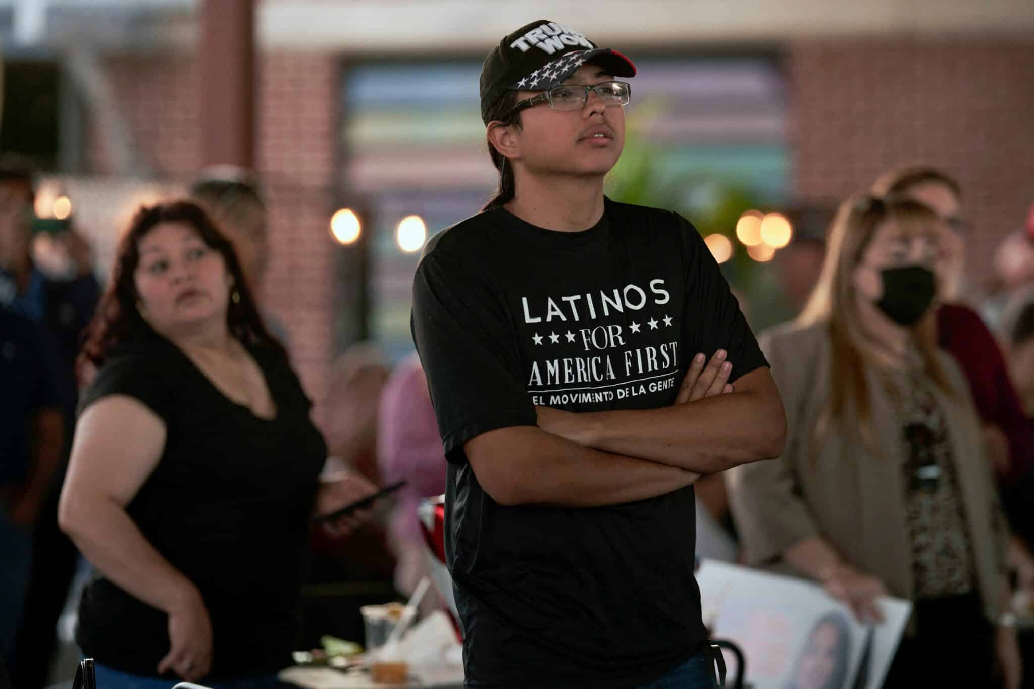 A man with a Latinos for America t-shirt attends a campaign event for Republican congressional candidate Monica De La Cruz and Representative Mayra Flores, who is running for reelection, on October 10, 2022 at the University Drafthouse in McAllen, Texas. (Photo by allison dinner / AFP) (Photo by ALLISON DINNER/AFP via Getty Images)