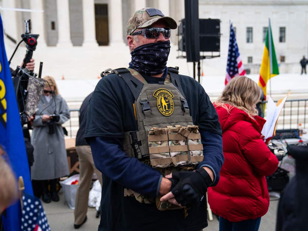 WASHINGTON, DC - JANUARY 05: A member of the right-wing group Oath Keepers stands guard during a rally in front of the U.S. Supreme Court Building on January 5, 2021 in Washington, DC. Today's rally kicks off two days of pro-Trump events fueled by President Trump's continued claims of election fraud and a last-ditch effort to overturn the results before Congress finalizes them on January 6.  (Photo by Robert Nickelsberg/Getty Images)