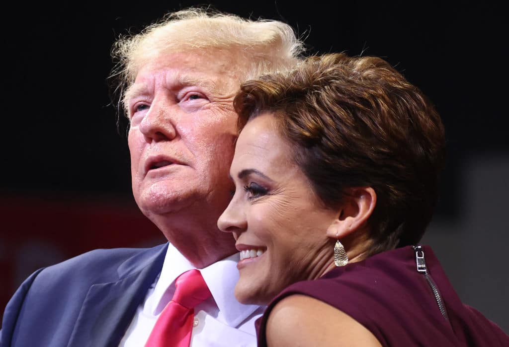 PRESCOTT VALLEY, ARIZONA - JULY 22: Former President Donald Trump (L) embraces Republican candidate for governor Kari Lake at a ‘Save America’ rally in support of Arizona GOP candidates on July 22, 2022 in Prescott Valley, Arizona. Arizona's primary election will take place August 2. (Photo by Mario Tama/Getty Images)