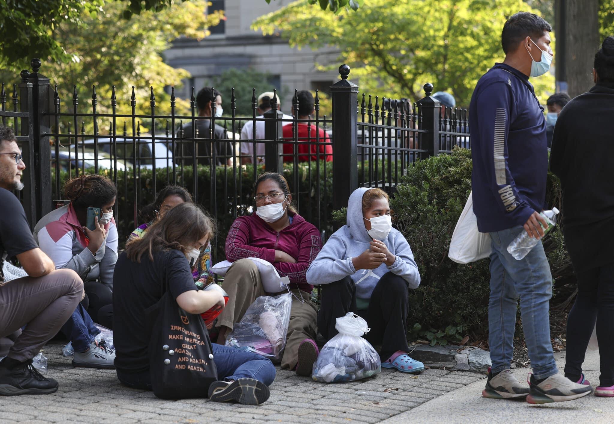 WASHINGTON, DC - SEPTEMBER 15: Migrants from Central and South America wait near the residence of US Vice President Kamala Harris after being dropped off on September 15, 2022 in Washington, DC. Texas Governor Greg Abbott dispatched buses carrying migrants from the southern border to Harris' home early Thursday morning. (Photo by Kevin Dietsch/Getty Images)