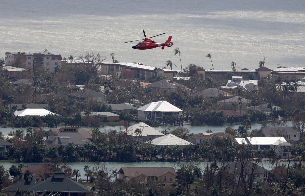 SANIBEL, FLORIDA - SEPTEMBER 29: In this aerial view, a Coast Guard helicopter flies over the island as search and rescue efforts continue after Hurricane Ian passed through the area on September 29, 2022 in Sanibel, Florida. The hurricane brought high winds, storm surge and rain to the area causing severe damage. (Photo by Joe Raedle/Getty Images)