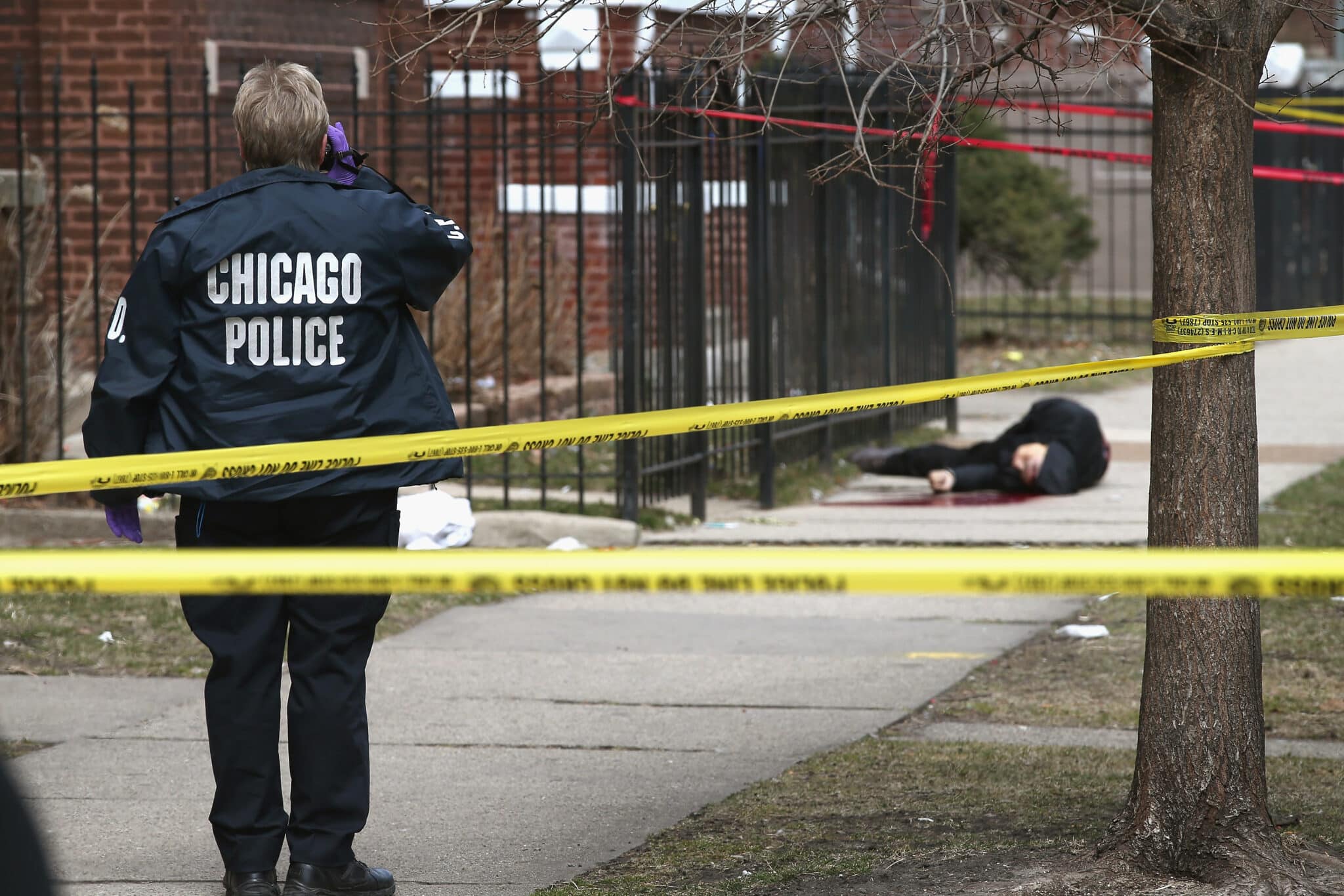 CHICAGO, IL - APRIL 01: (EDITORS NOTE: Image contains graphic content.) Chicago police investigate the murder of a 24-year-old man who was shot and killed on South Eberhart Avenue on the city's South Side April 1, 2013 in Chicago, Illinois. According to published reports, the man was the 73rd homicide victim and the 39th victim under the age of 25 in Chicago in 2013.  (Photo by Scott Olson/Getty Images)