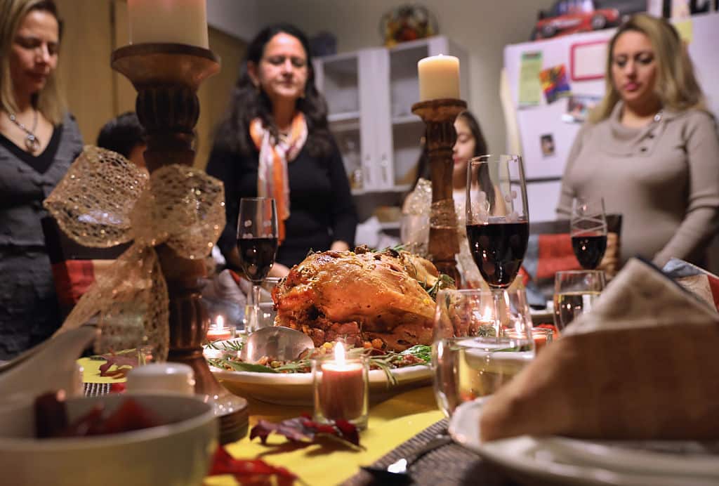 STAMFORD, CT - NOVEMBER 24:  Central American immigrants and their families pray before Thanksgiving dinner on November 24, 2016 in Stamford, Connecticut. Family and friends, some of them U.S. citizens, others on work visas and some undocumented immigrants came together in an apartment to celebrate the American holiday with turkey and Latin American dishes. They expressed concern with the results of the U.S. Presidential election of president-elect Donald Trump, some saying their U.S.-born children fear the possibilty their parents will be deported after Trump's inauguration.  (Photo by John Moore/Getty Images)