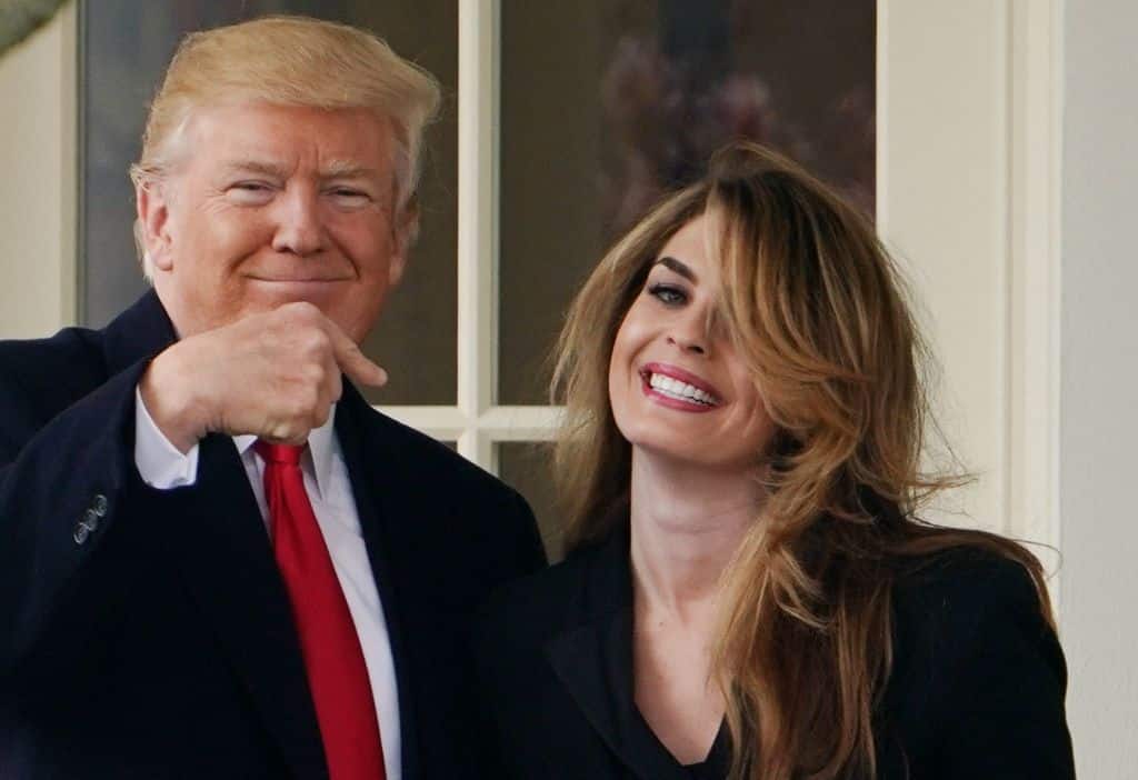 US President Donald Trump points to former communications director Hope Hicks shortly before making his way to board Marine One on the South Lawn and departing from the White House on March 29, 2018. - Trump is visiting Ohio to speak on infrastructure development before heading to Palm Beach, Florida. (Photo by Mandel NGAN / AFP) (Photo by MANDEL NGAN/AFP via Getty Images)