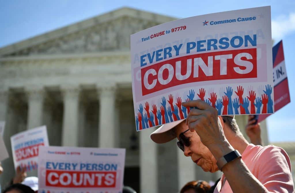Demonstrators rally at the US Supreme Court in Washington, DC, on April 23, 2019, to protest a proposal to add a citizenship question in the 2020 Census. - In March 2018, US Secretary of Commerce Wilbur Ross announced he was going to reintroduce for the 2020 census a question on citizenship abandoned more than 60 years ago. The decision sparked an uproar among Democrats and defenders of migrants -- who have come under repeated attack from an administration that has made clamping down on illegal migration a hallmark as President Donald Trump seeks re-election in 2020. (Photo by MANDEL NGAN / AFP)        (Photo credit should read MANDEL NGAN/AFP via Getty Images)