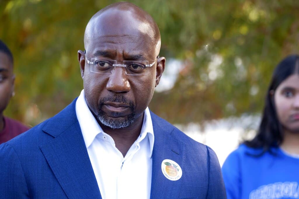 U.S. Sen, Raphael Warnock, D-Ga., speaks to journalists after voting on the first day of early voting in Atlanta on Monday, Oct. 17, 2022. (AP Photo/Ben Gray)