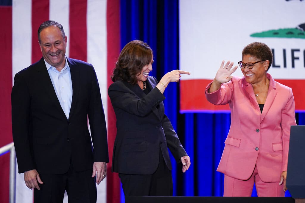 Joined by husband Doug Emhoff, left, Vice President Kamala Harris, center, points to Los Angeles mayoral candidate Rep. Karen Bass, D-Calif., after speaking at a campaign rally in Los Angeles, Monday, Nov. 7, 2022. (AP Photo/Jae C. Hong)