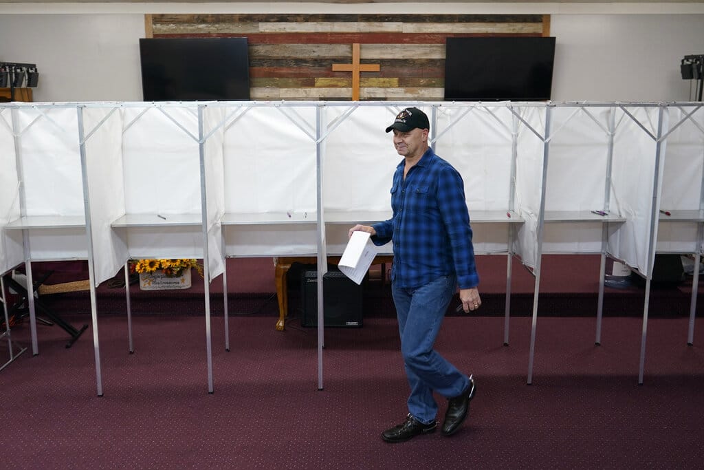 Pennsylvania Republican gubernatorial candidate Doug Mastriano walks with his completed ballot to put it into a voting machine to vote at his polling place, the New LIFE Worship Center Church of God, in Fayetteville, Pa., Tuesday, Nov. 8, 2022. (AP Photo/Carolyn Kaster)