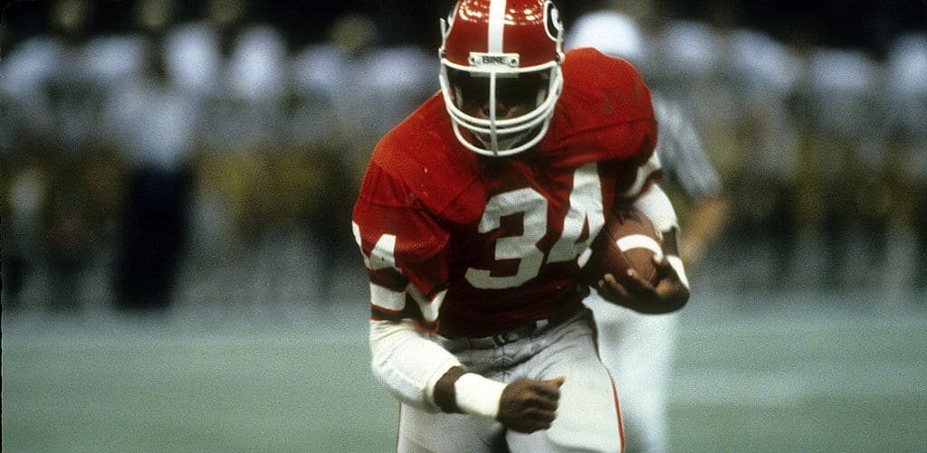 LOUISIANA, NO - JANUARY 1:  Running back Herschel Walker #34 of the University of Georgia Bull Dogs carries the ball against the Notre Dame Fighting Irish during the Sugar Bowl game January 1, 1981 at the Louisiana Superbowl in New Orleans, Louisiana. The Bull Dogs won the game 17-10. Walker played at the University of Georgia from 1980-1983, and won the Heisman Trophy in 1982. (Photo by Focus on Sport/Getty Images)