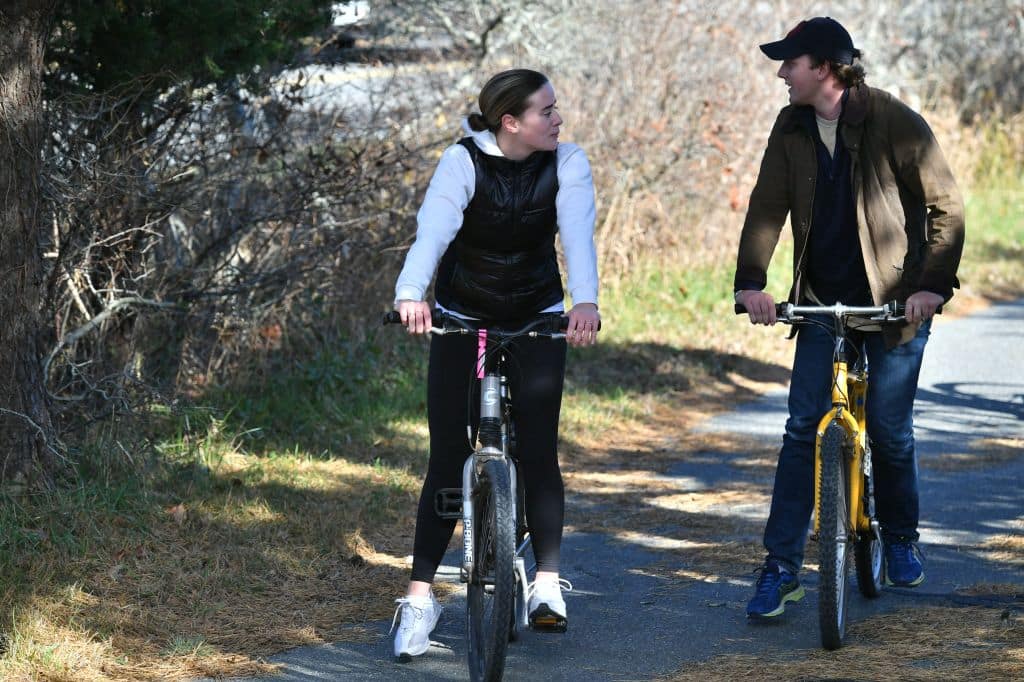 Naomi Biden the granddaughter of US President Joe Biden and her fiancé Peter Neal ride bikes in Nantucket, Massachusetts on November 23, 2021. Biden is in Nantucket to spend the Thanksgiving holiday. - Biden is in Nantucket to spend the Thanksgiving holiday. (Photo by MANDEL NGAN / AFP) (Photo by MANDEL NGAN/AFP via Getty Images)