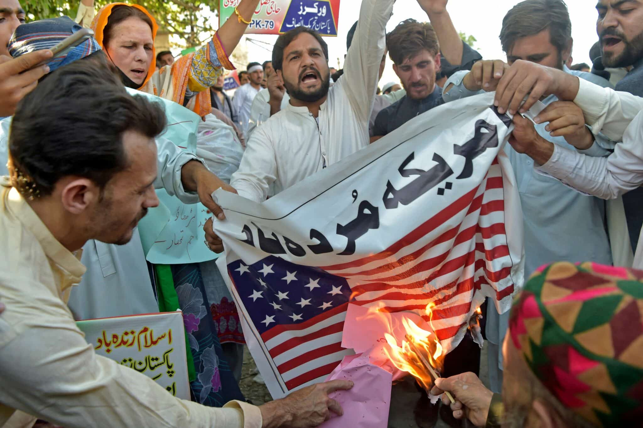 Supporters of ruling Pakistan Tehreek-e-Insaf (PTI) party burn a US national flag during an anti-US protest in Peshawar on April 1, 2022. - Pakistan's Prime Minister Imran Khan on March 31 accused the United States of meddling in Pakistan's politics  -- a claim quickly denied by Washington -- as a debate on a no-confidence motion against him in parliament was postponed. (Photo by Abdul MAJEED / AFP) (Photo by ABDUL MAJEED/AFP via Getty Images)