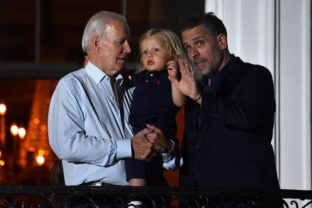 US President Joe Biden (L) holds grandson Beau Biden next to son Hunter Biden (R) on a balcony of the White House to watch 4th of July fireworks in Washington, DC, July 4, 2022. (Photo by Nicholas Kamm / AFP) (Photo by NICHOLAS KAMM/AFP via Getty Images)