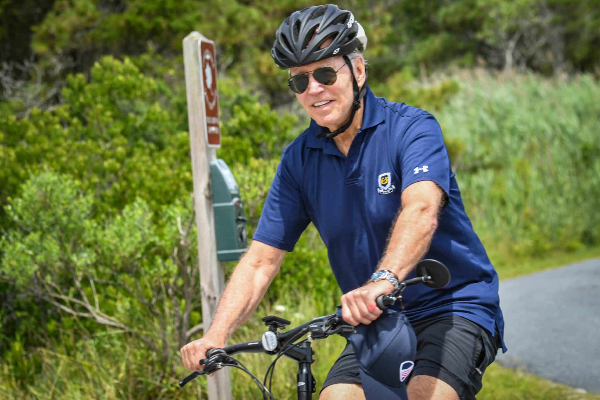 US President Joe Biden rides a bike through Gordon's Pond State Park in Rehoboth Beach, Delaware on July 10, 2022. (Photo by Nicholas Kamm / AFP) / The erroneous mention[s] appearing in the metadata of this photo by Nicholas Kamm has been modified in AFP systems in the following manner: [Rehoboth Beach] instead of [Rehobeth Beach]. Please immediately remove the erroneous mention[s] from all your online services and delete it (them) from your servers. If you have been authorized by AFP to distribute it (them) to third parties, please ensure that the same actions are carried out by them. Failure to promptly comply with these instructions will entail liability on your part for any continued or post notification usage. Therefore we thank you very much for all your attention and prompt action. We are sorry for the inconvenience this notification may cause and remain at your disposal for any further information you may require. (Photo by NICHOLAS KAMM/AFP via Getty Images)