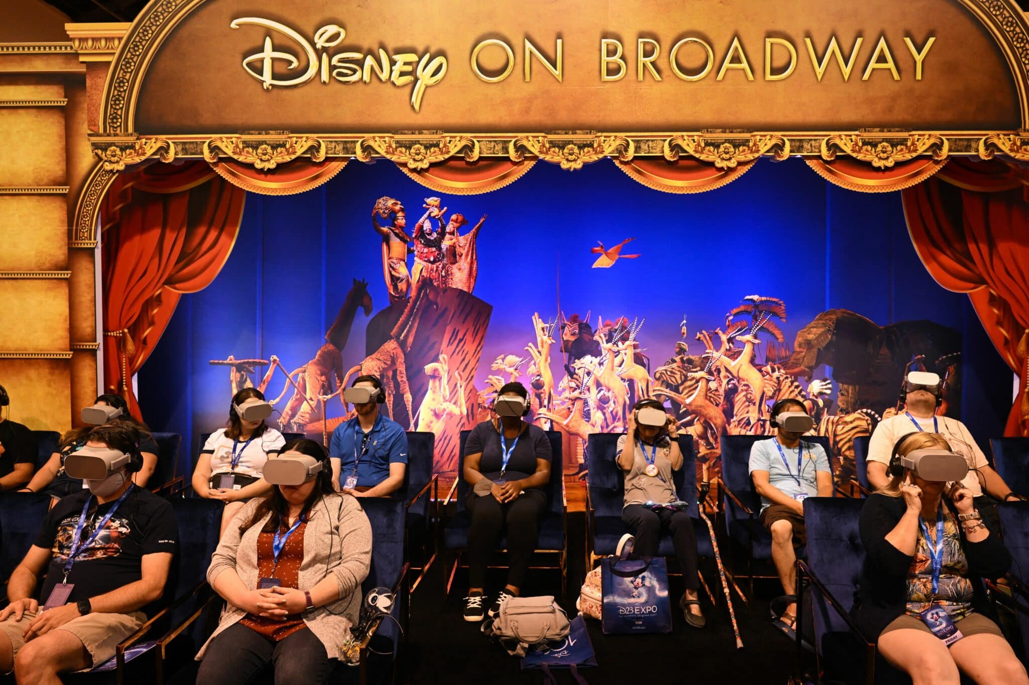 Attendees watch a virtual reality headset presentation of Disney On Broadway shows including The Lion King during the Walt Disney D23 Expo in Anaheim, California on September 9, 2022. (Photo by Patrick T. FALLON / AFP) (Photo by PATRICK T. FALLON/AFP via Getty Images)