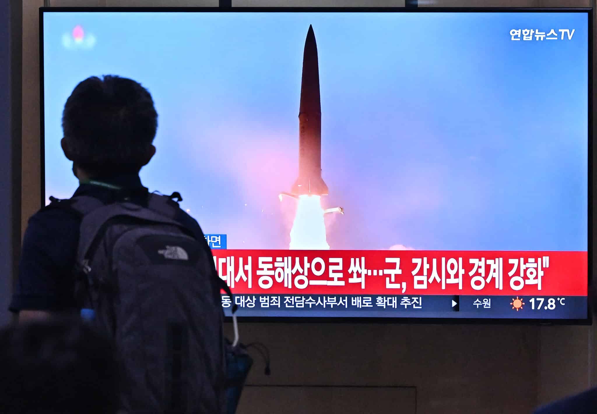 A man walks past a television screen showing a news broadcast with file footage of a North Korean missile test, at a railway station in Seoul on September 29, 2022. - North Korea fired two ballistic missiles on September 29, just hours after US Vice President Kamala Harris left South Korea, where she had toured the heavily-fortified Demilitarized Zone which divides the peninsula. (Photo by Jung Yeon-je / AFP) (Photo by JUNG YEON-JE/AFP via Getty Images)