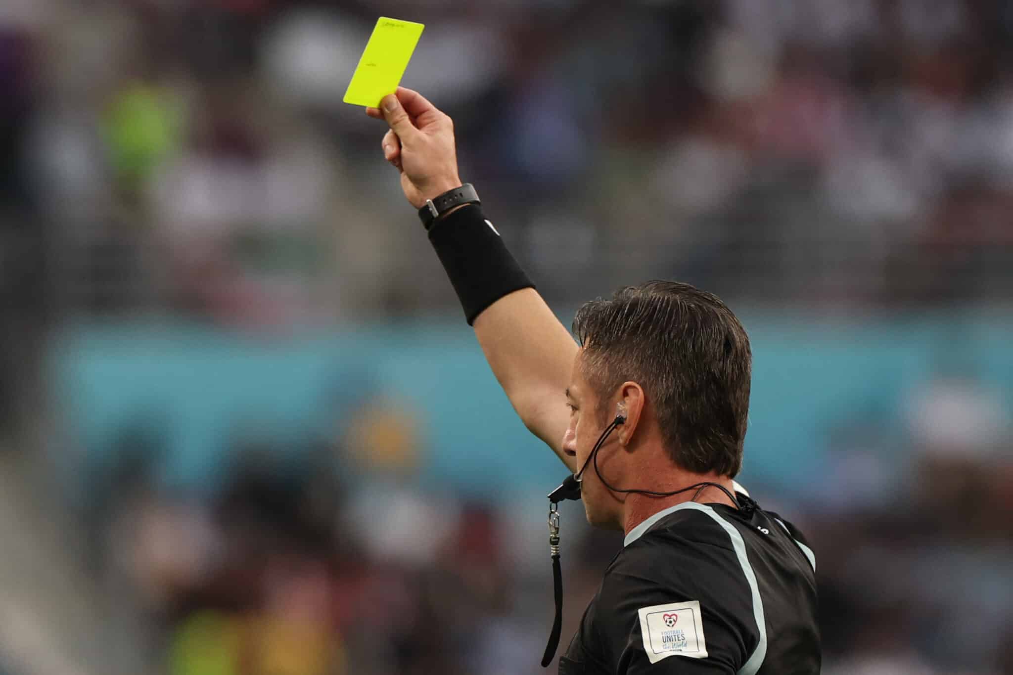 Brazilian referee Raphael Claus issues a yellow card to Iran's midfielder #07 Alireza Jahanbakhsh during the Qatar 2022 World Cup Group B football match between England and Iran at the Khalifa International Stadium in Doha on November 21, 2022. (Photo by Giuseppe CACACE / AFP) (Photo by GIUSEPPE CACACE/AFP via Getty Images)