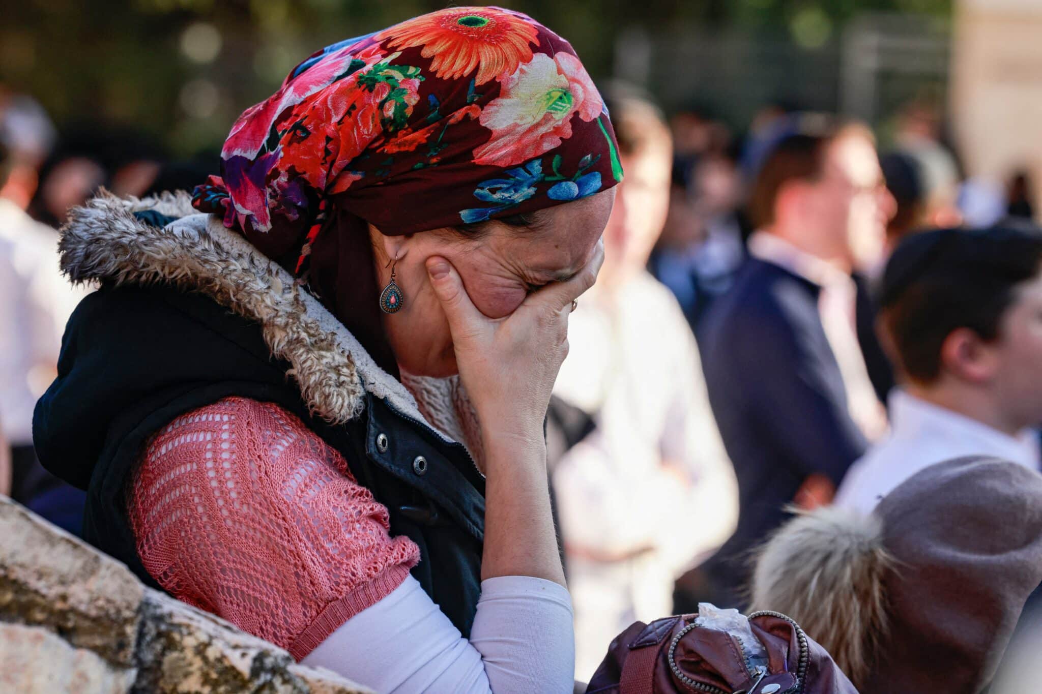 A woman mourner reacts during the funeral of Aryeh Schupak, 15, an Israeli-Canadian killed in an attack on a bus stop in Jerusalem on November 23, 2022. - Explosions hit two bus stops in Jerusalem on November 23, killing a teen and wounding 14, in unclaimed attacks cheered by Palestinian militant group Hamas. The first bombings to hit Jerusalem since 2016, according to security officials, targeted an area frequented by ultra-Orthodox Jews at the western exit from Jerusalem. (Photo by Menahem KAHANA / AFP) (Photo by MENAHEM KAHANA/AFP via Getty Images)