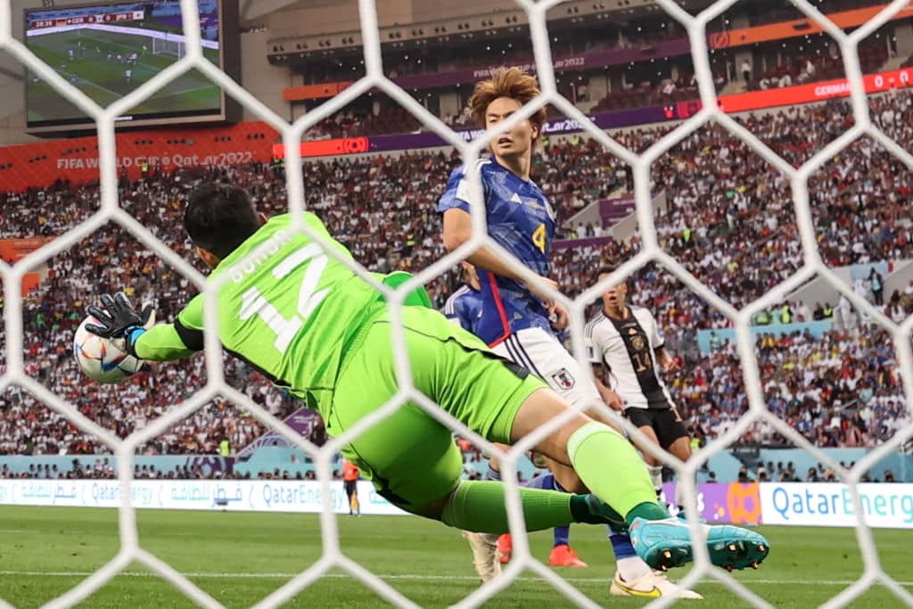 Japan's goalkeeper #12 Shuichi Gonda saves a shot during the Qatar 2022 World Cup Group E football match between Germany and Japan at the Khalifa International Stadium in Doha on November 23, 2022. (Photo by ADRIAN DENNIS / AFP) (Photo by ADRIAN DENNIS/AFP via Getty Images)